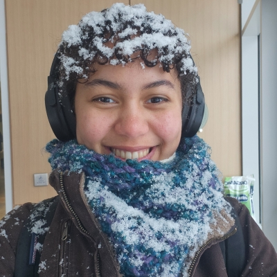 Portrait of curly haired mixed woman with snow on hair