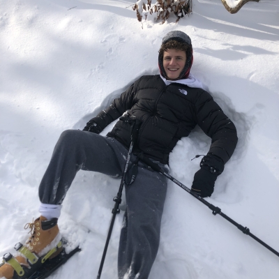 Sitting down in the snow with snow shoes on 
