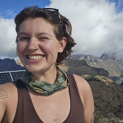 Selfie of Valen, smiling, on the summit of Emory Peak in Big Bend National Park, Texas. 