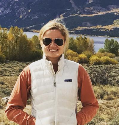 woman in front of majestic mountains