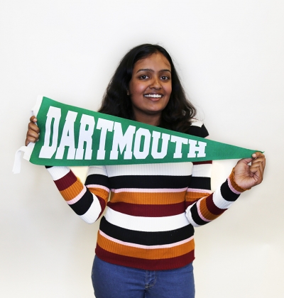 Female student holding a Dartmouth pennant posing for portrait