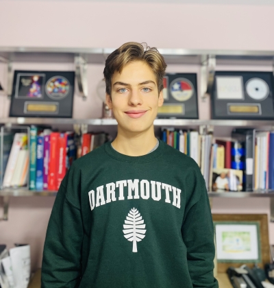 Nathan in his Dartmouth sweatshirt in his bedroom