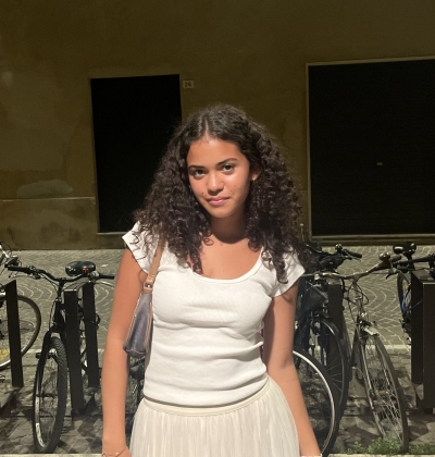 Portrait of Gabi in front of bikes on a city street