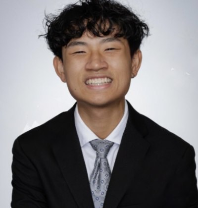 Tao smiling wearing a suit