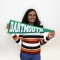 Female student holding a Dartmouth pennant posing for portrait