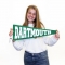 Student smiling holding Dartmouth banner