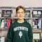 Nathan in his Dartmouth sweatshirt in his bedroom