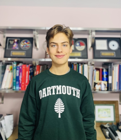 Nathan in his Dartmouth sweatshirt in his bedroom