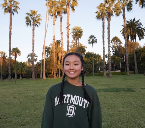 Madison smiling in front of palm trees