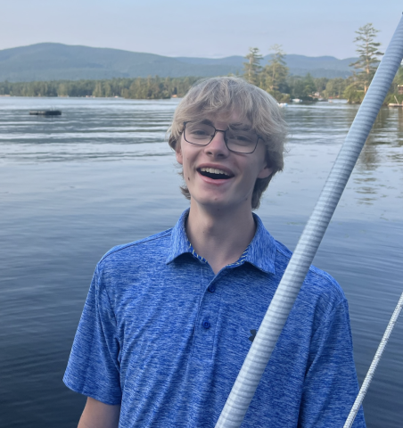Cooper smiling in front of the water