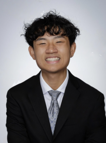 Tao smiling wearing a suit