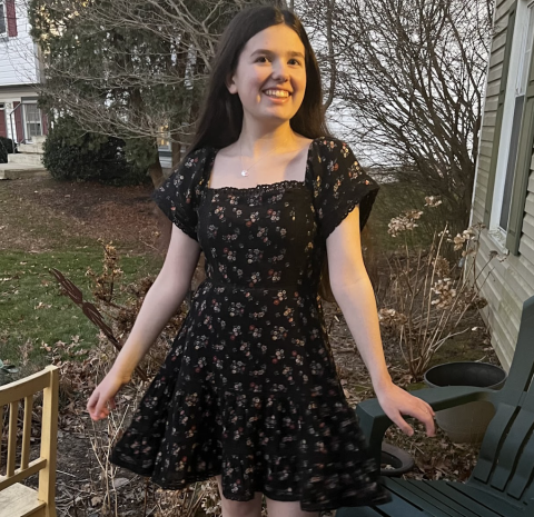 Eloise smiling wearing a black dress