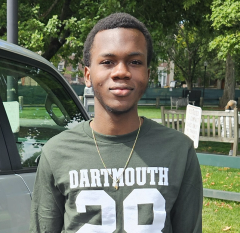 Nuna smiling wearing a Dartmouth 28 shirt