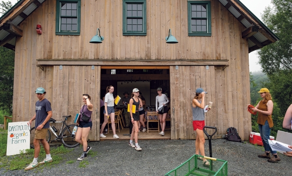 A photo of Students exit the Organic Farm's barn that functions as both a classroom and community space.