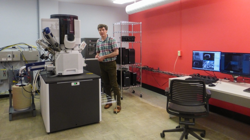 Maxime Guinel, director of the Electron Microscope Facility, shows off the state-of-the-art scanning electron microscope, which lets scientists see under the surface of the materials they study. 