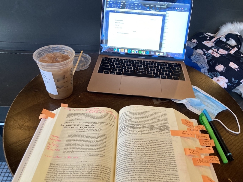 A book, laptop, and coffee