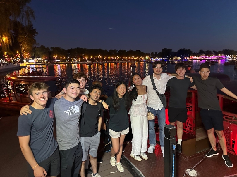7 boys and 2 girls taking a photo and smiling in the evening in Beijing