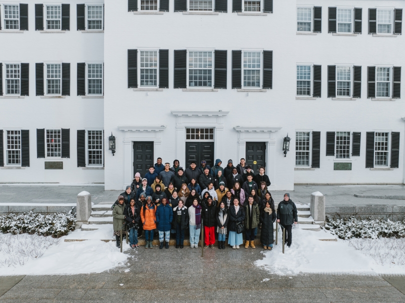 A group of students line the steps of a snowy Dartmouth Hall.