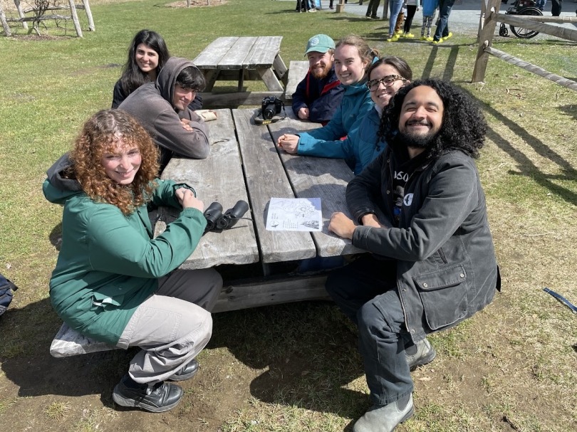A picture of Kalina's friends sitting at a table outside the Vermont Institute of Natural Science in the sun