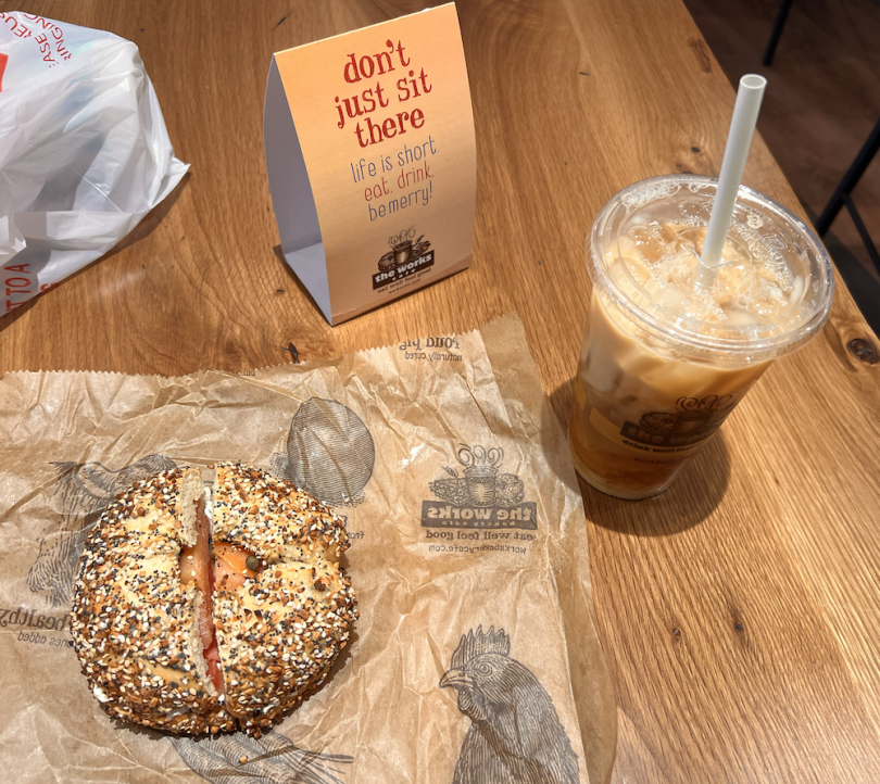 Bagel and iced coffee on the table.