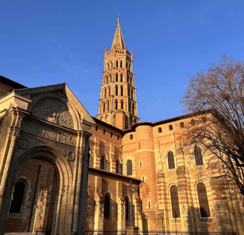 Sunset hitting the pink exterior of the biggest basilica in Toulouse