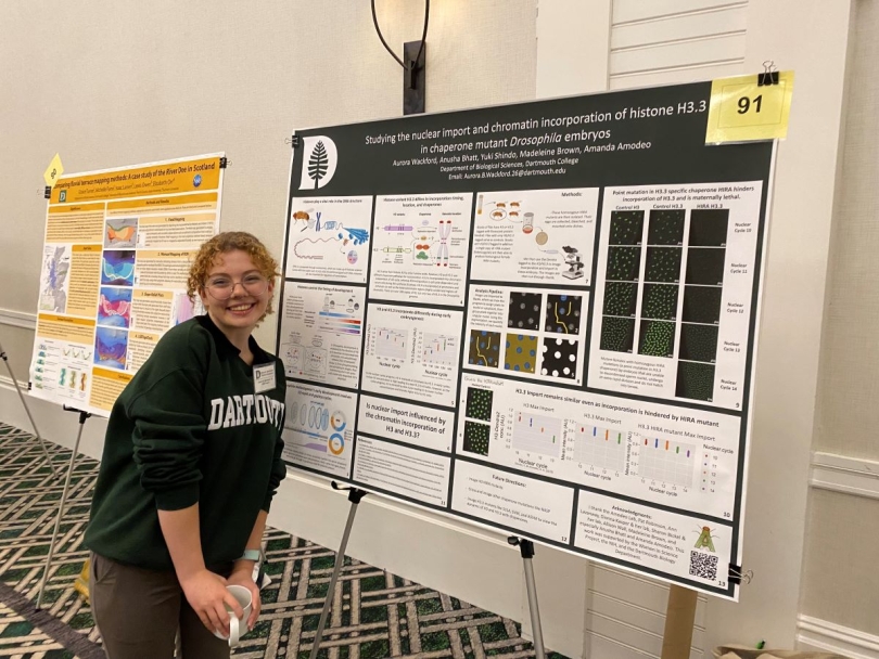 A picture of a fellow researcher presenting her poster.
