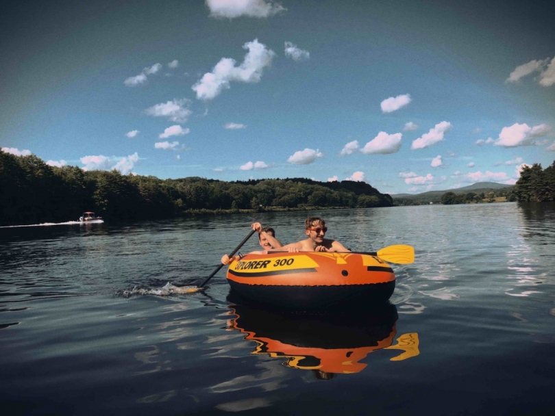 People rowing an inflatable boat on a river
