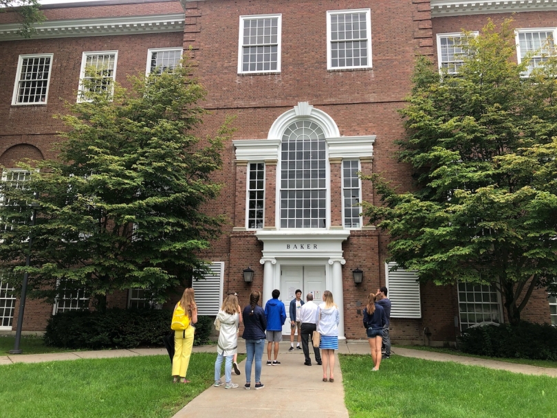 A tour group in front of large brick building