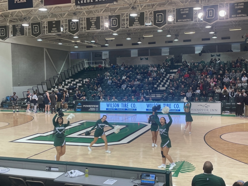The Dartmouth basketball court with cheerleaders running cheering on the crowd!