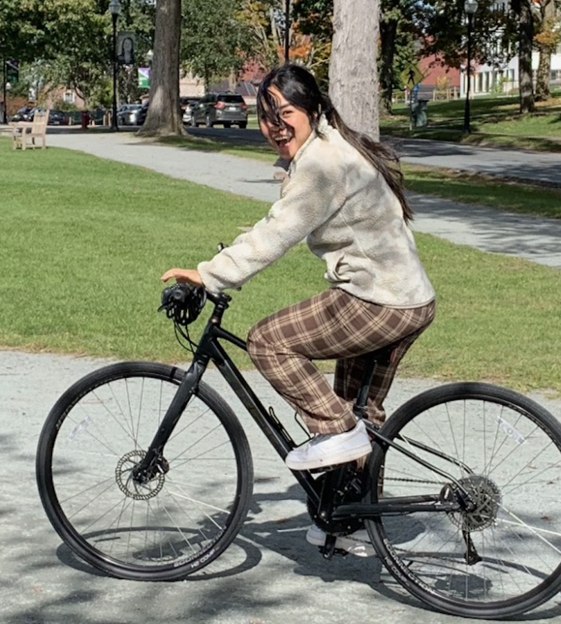 Ningning rides a bicycle on the Green.