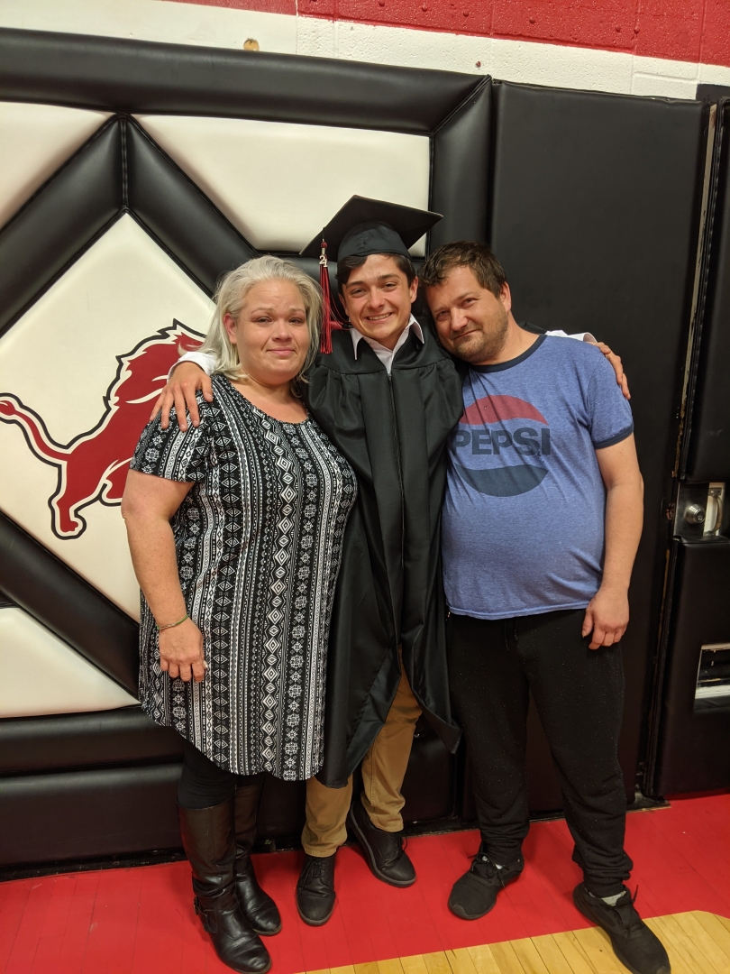 Photo of me and my family at my high school graduation