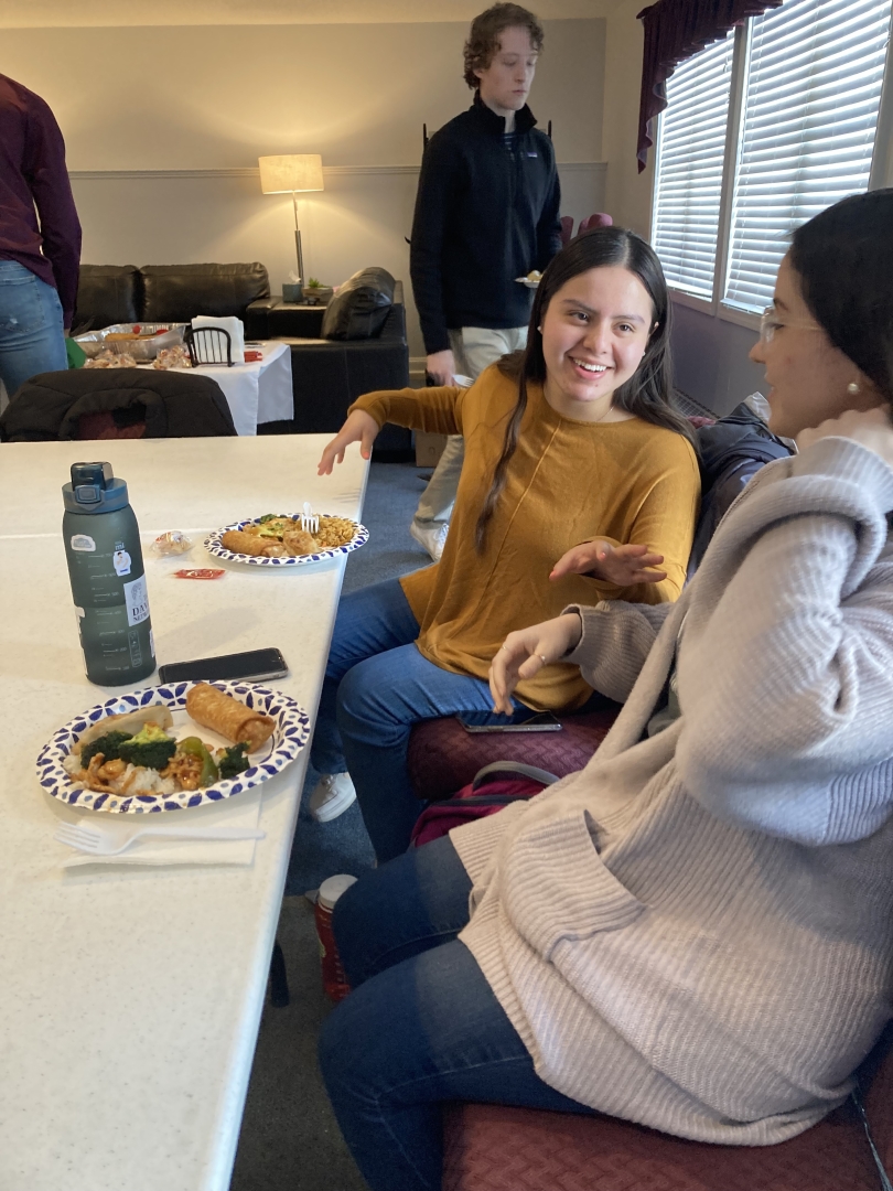 Two group members talking over a meal