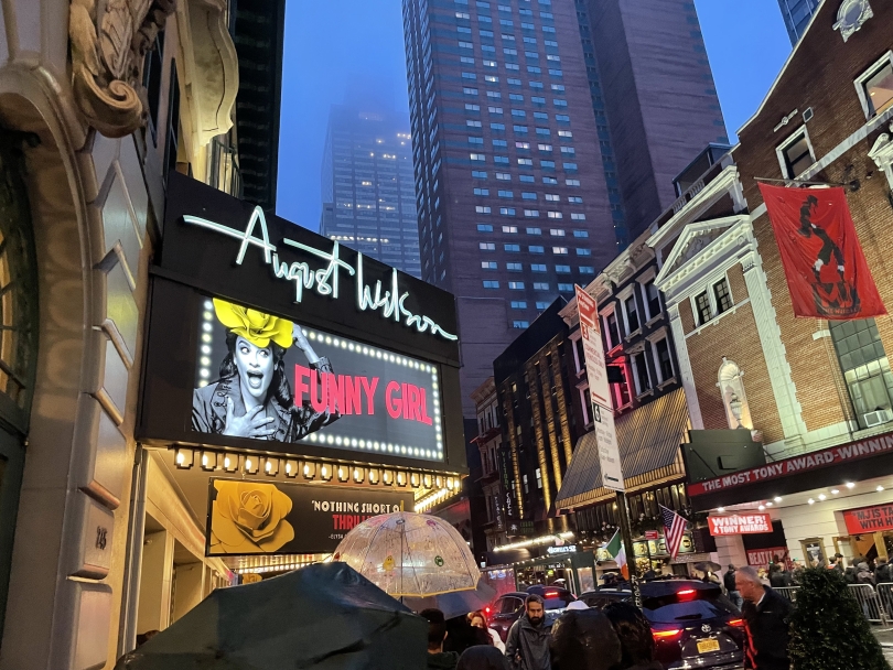 An image outside a Broadway musical venue at night on the New York City Times Square strip