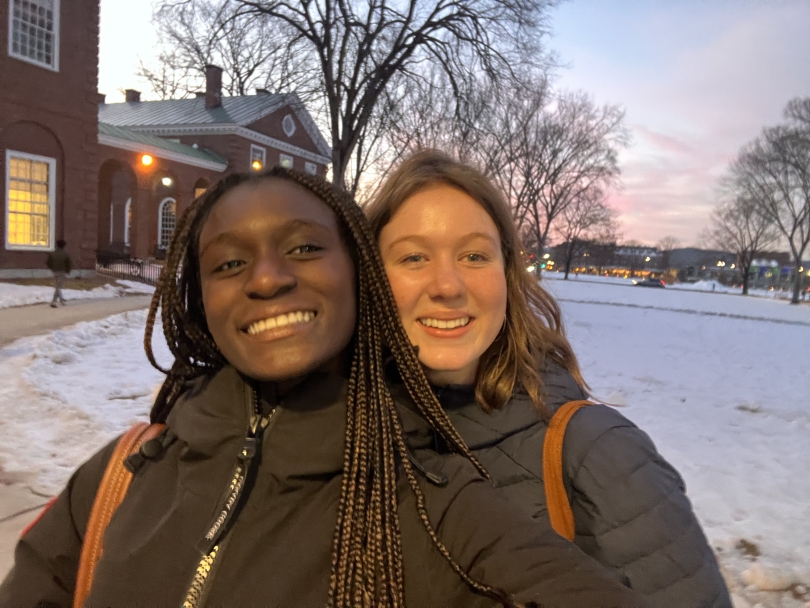 Selfie of me and my friend outside of Baker Library. The ground is covered with snow!