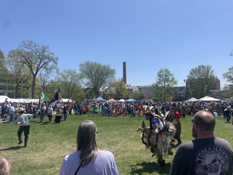 An image taken on a sunny day just outside the center circle powwow dancing arena on the green—Dartmouth's 51st annual powwow