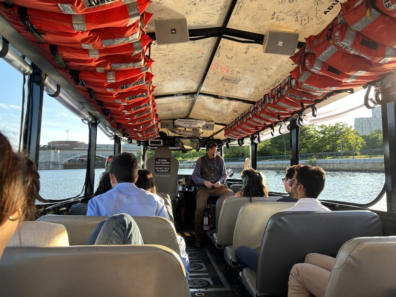 Participating in duck boat tour across the Charles River Listening to tour guide on duck boat tour across Charles River