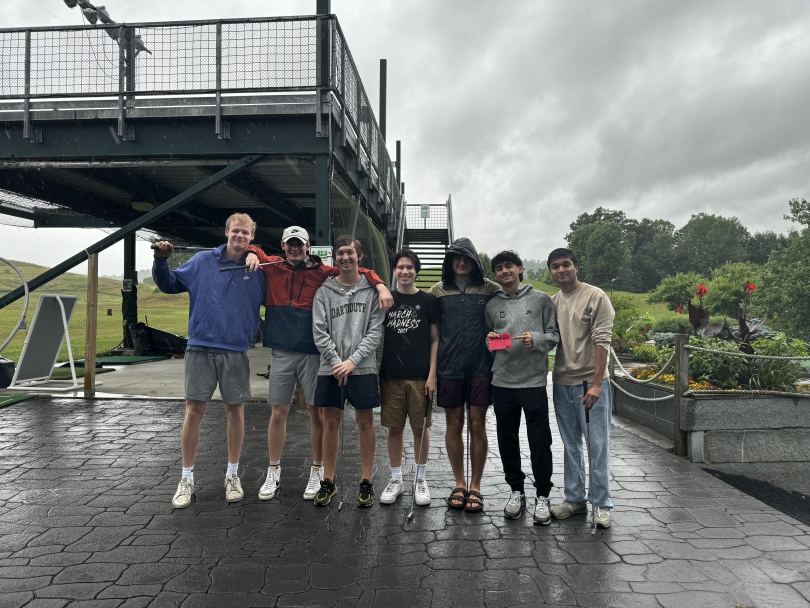 A group picture of six friends and me holding golf clubs on a rainy afternoon at a local miniature golf course in West Lebanon, New Hampshire