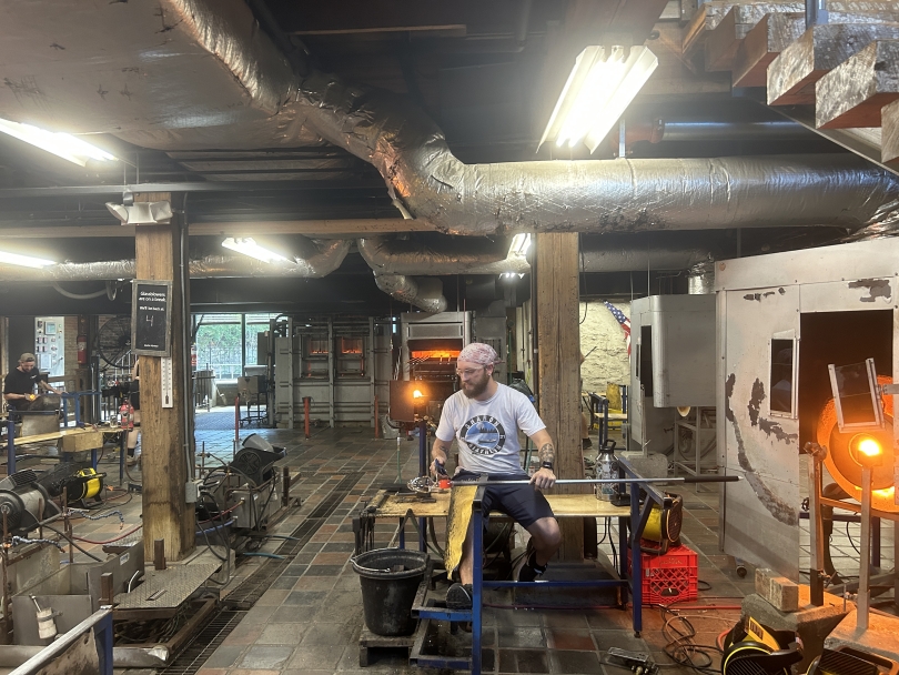 Man working the glass making station at Simon Pearce 