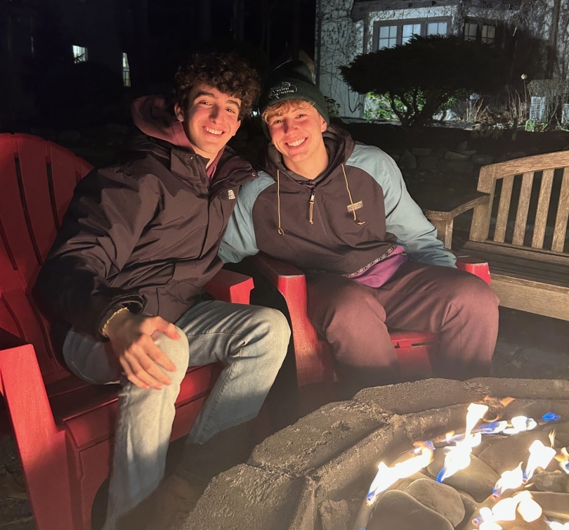 martin and his friend daniel smiling in front of the fire pit and embracing!