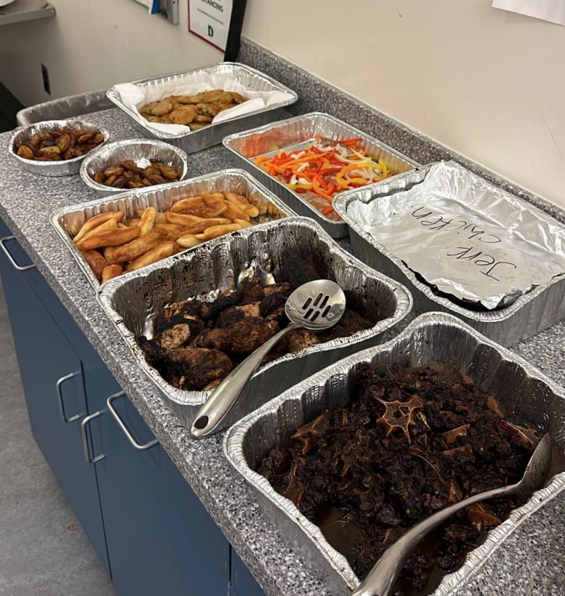 Caribbean food is displayed in aluminum pans during Shabazz's Sunday dinner.