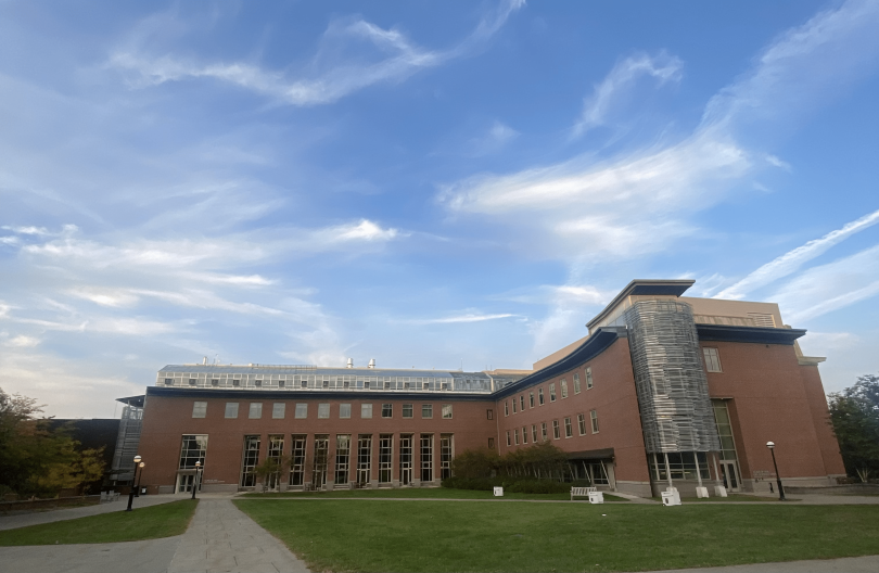 a clear-sky view of the life sciences center, a brick building positioned on a farther side of campus