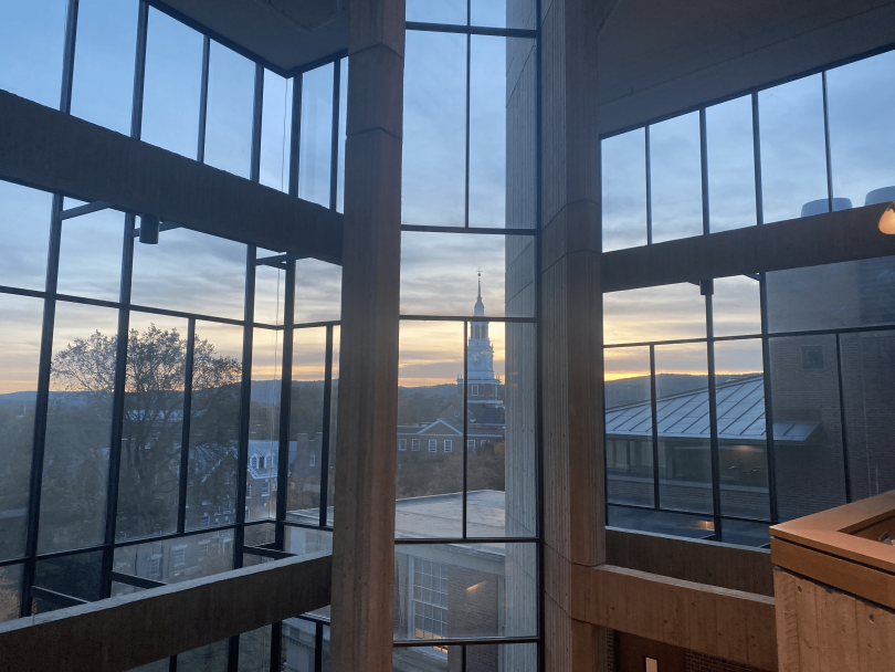 a view of baker-berry during a sunset through the large glass windows of the fairchild physical sciences center