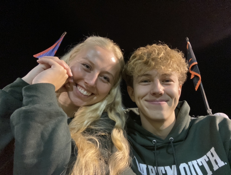 martin and his sister taking a selfie at the Dartmouth versus Upenn men's soccer game