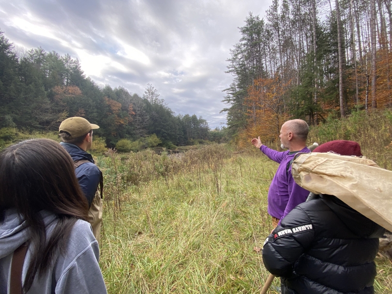 martin's lab director craig indicating where the group will be going in the stream