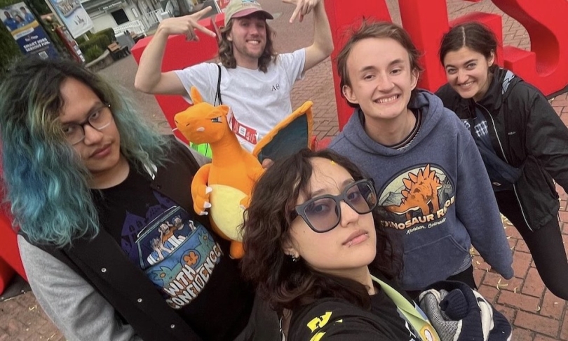 A group of five Dartmouth students in front of a sign that says Six Flags