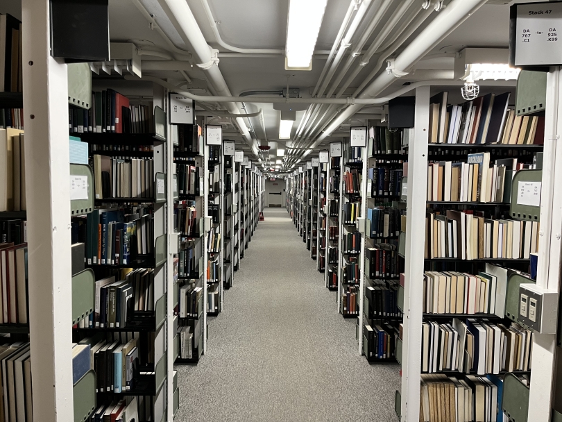 A picture of many rows of library book stacks fading into the distance
