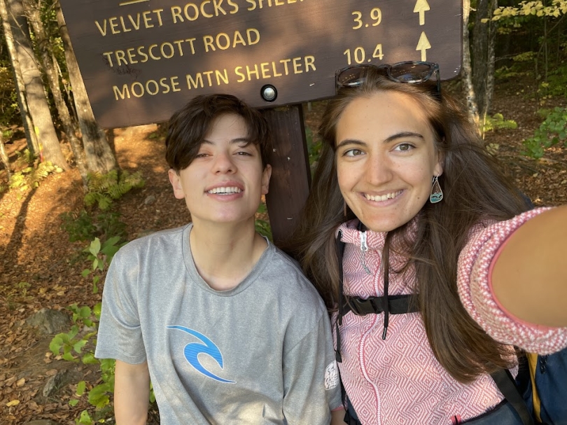 a picture of Kalina and her friend Ari before a trailhead sign