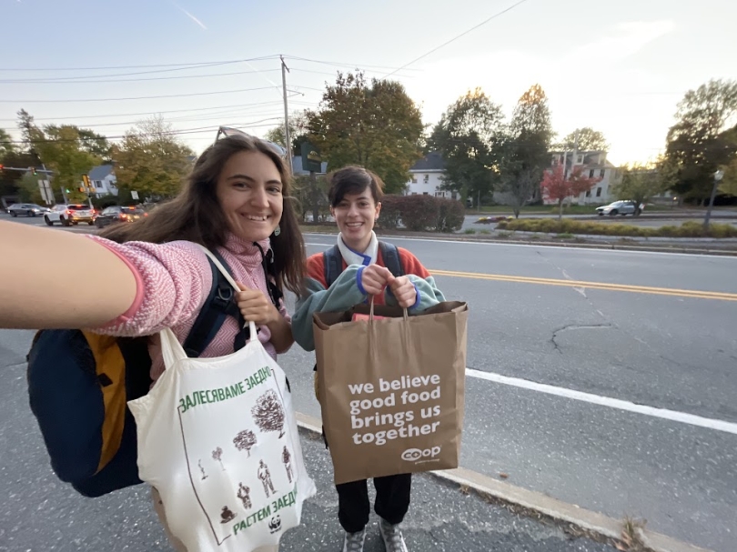 a picture of Kalina and Ari holding two big bags full of groceries