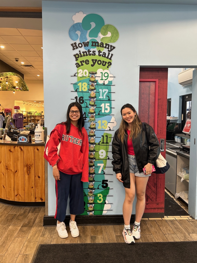 Diana '23 and Joanna '23 standing in front of ice cream poster in the factory lobby