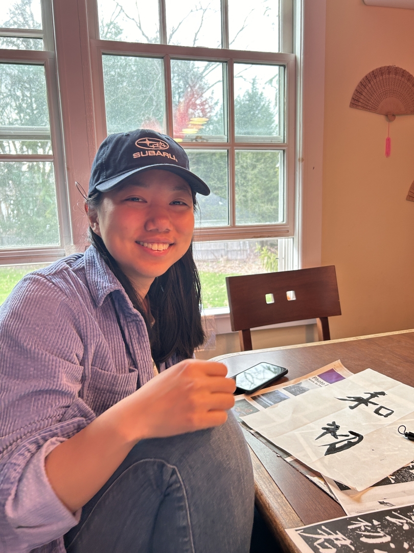 Kate '24 works on her calligraphy in the Chinese Language House